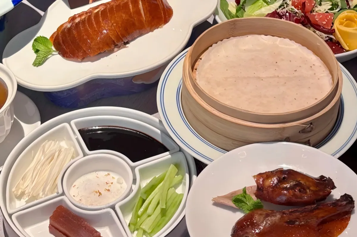 Peking duck carved tableside with pancakes, sweet bean sauce, and scallions